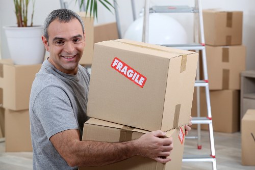 Man and van loading furniture in Hackney street setting