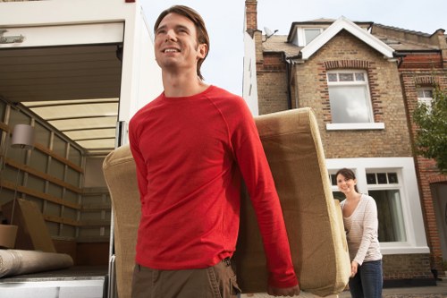 Local Hackney removals team loading furniture into a van