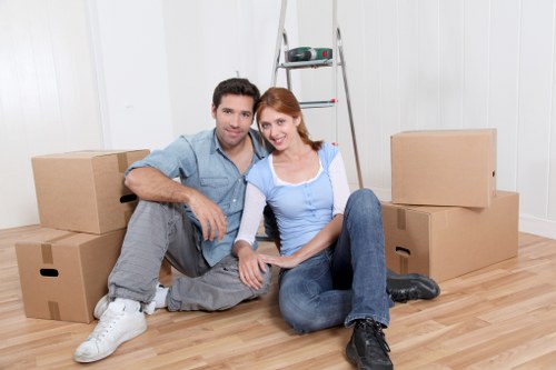 Professional movers handling furniture on a Hackney street